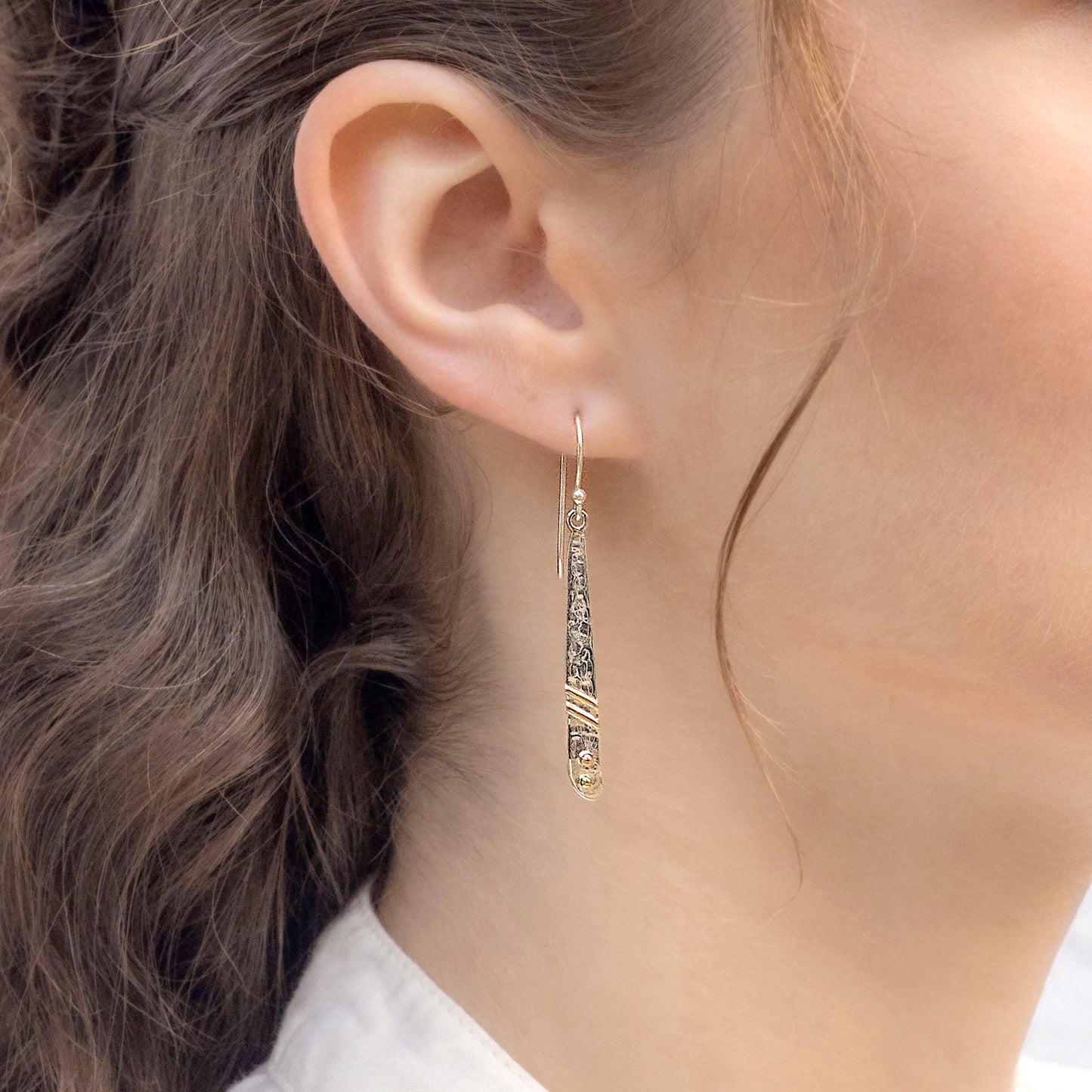 Sterling Textured Silver Brass & Copper Detail Drop Earrings worn by a person with wavy hair.