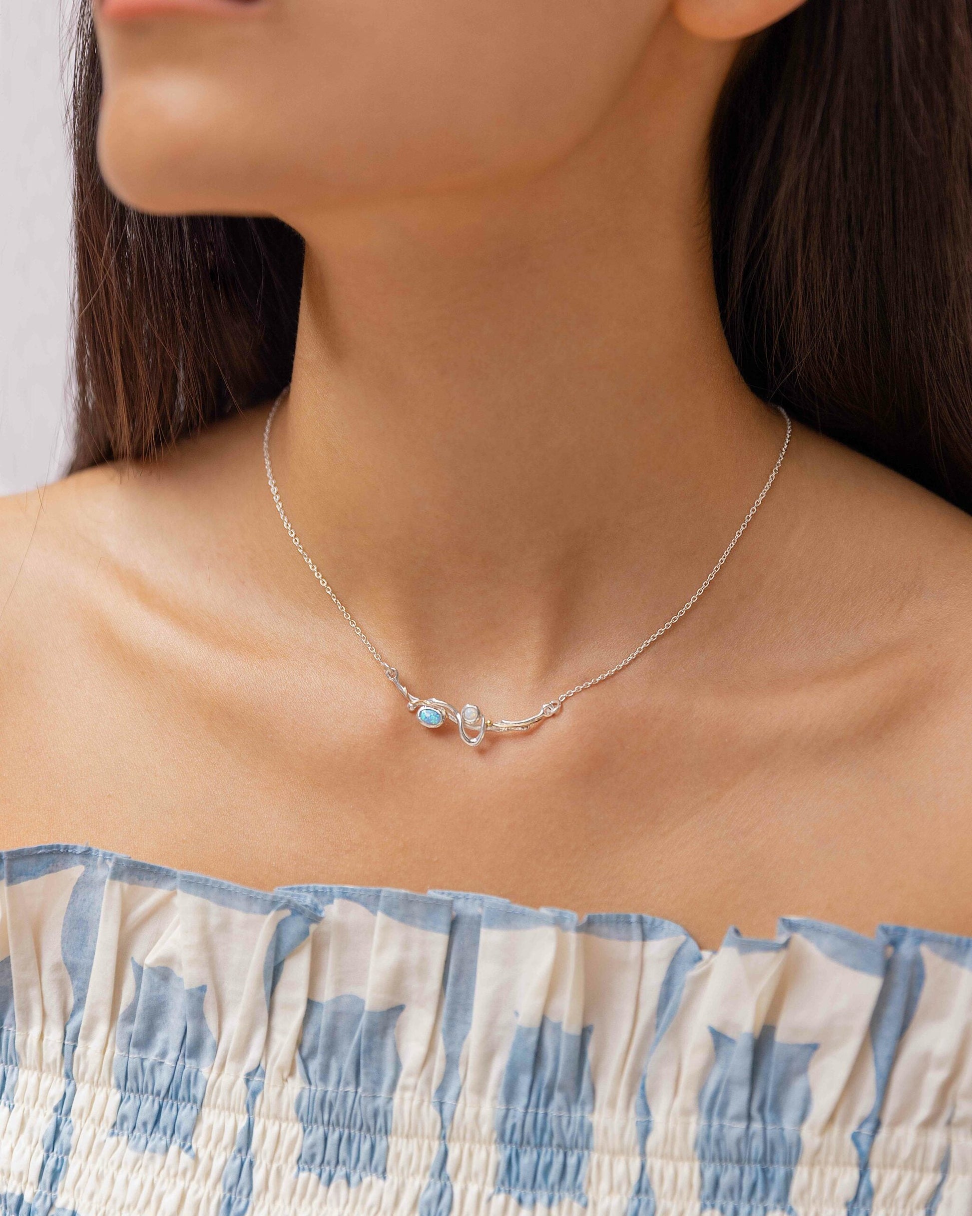 Sterling Silver Inline Opalite & 14 carat Yellow Gold Detailed Necklace worn on a woman's neck