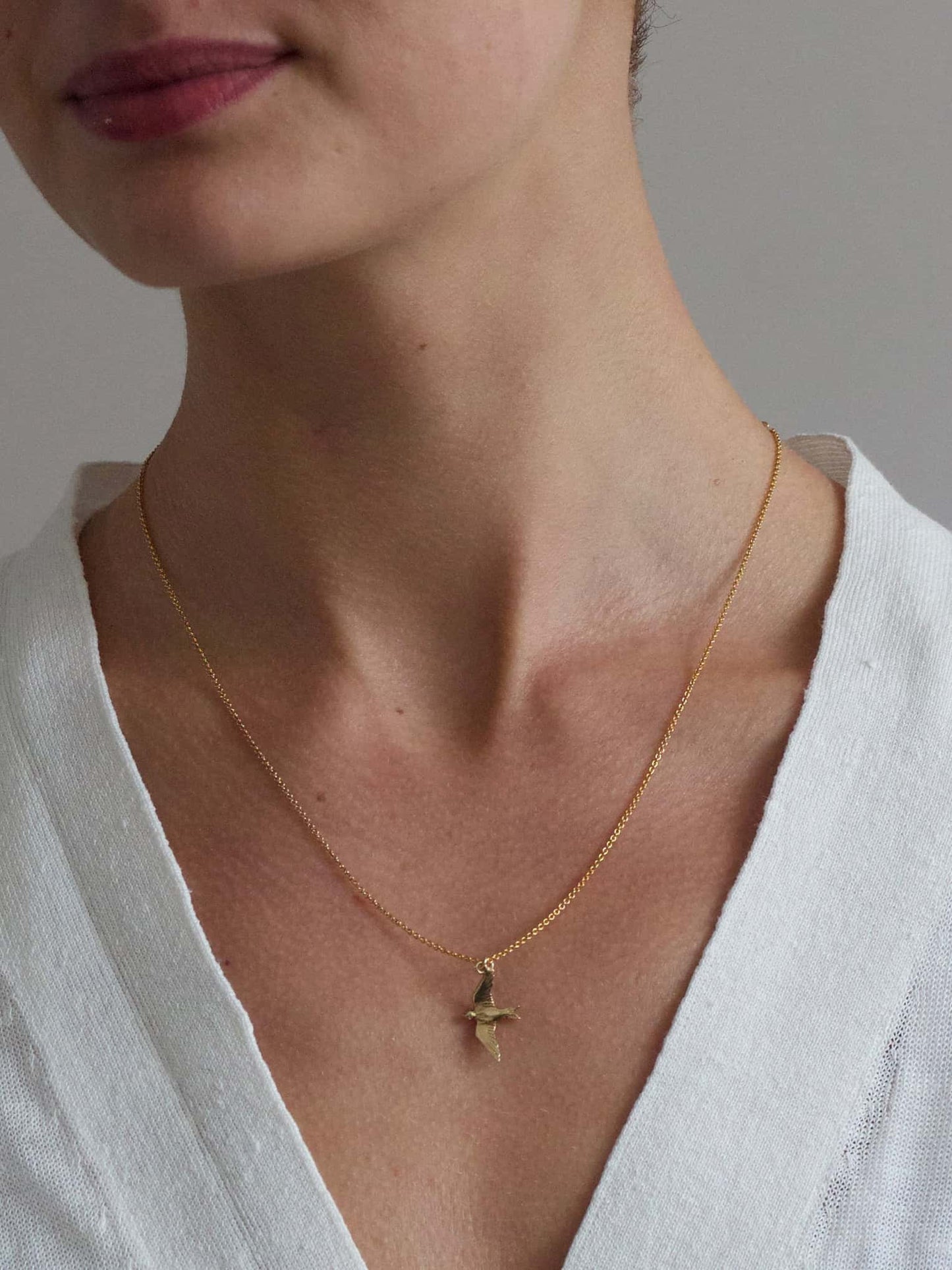 Alex Monroe 22 carat Yellow Gold Vermeil Flying Swallow Necklace worn by a model