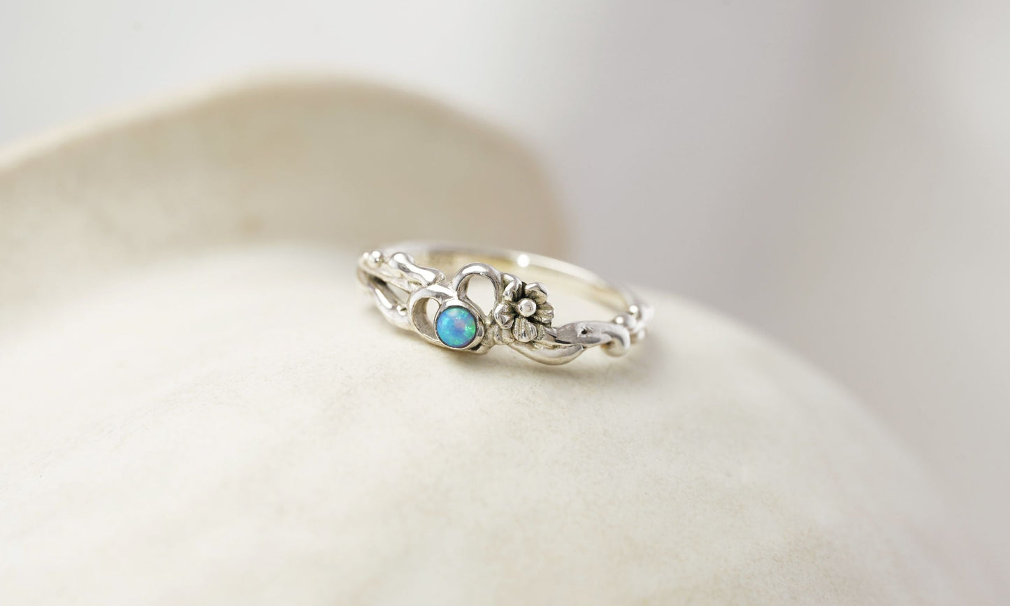 Silver ring with a turquoise stone on a white background